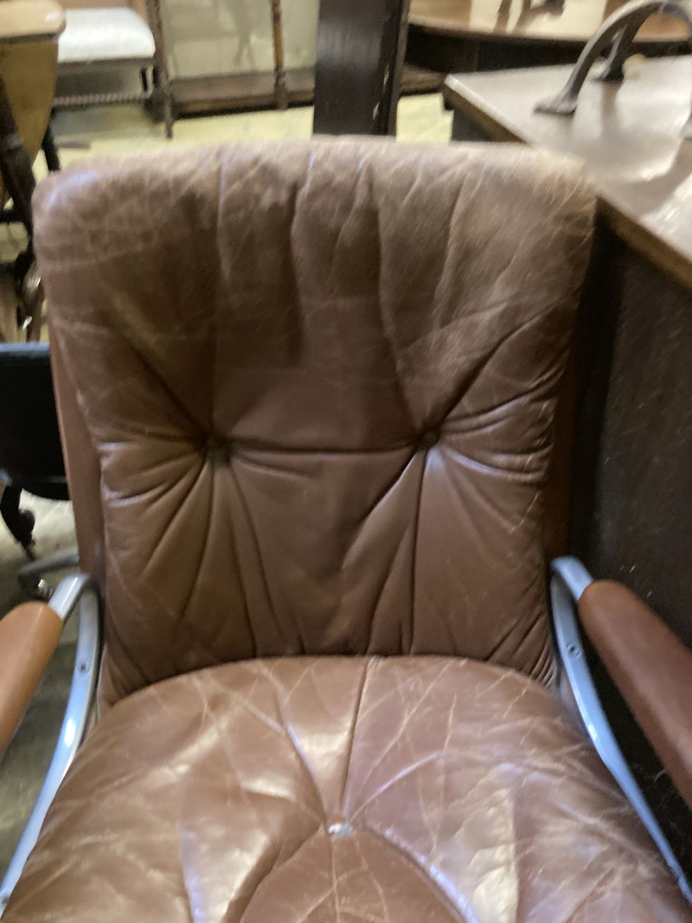 A Norwegian Ring Mekanikk swivel chair upholstered in brown leather